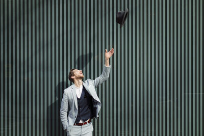 Full length of a young man looking up in city