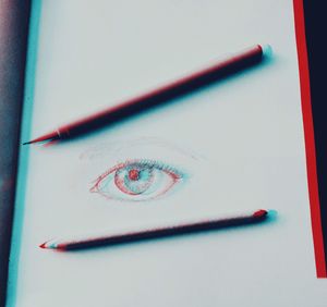 High angle view of colored pencils on book