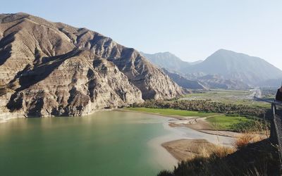 Scenic view of lake and mountains against clear sky