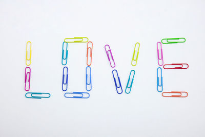 Close-up of colored pencils over white background