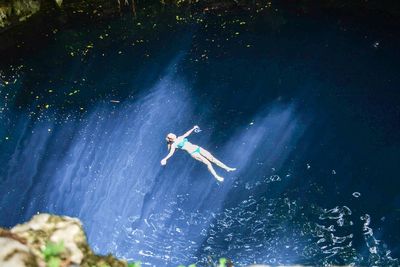 Low angle view of man swimming in sea