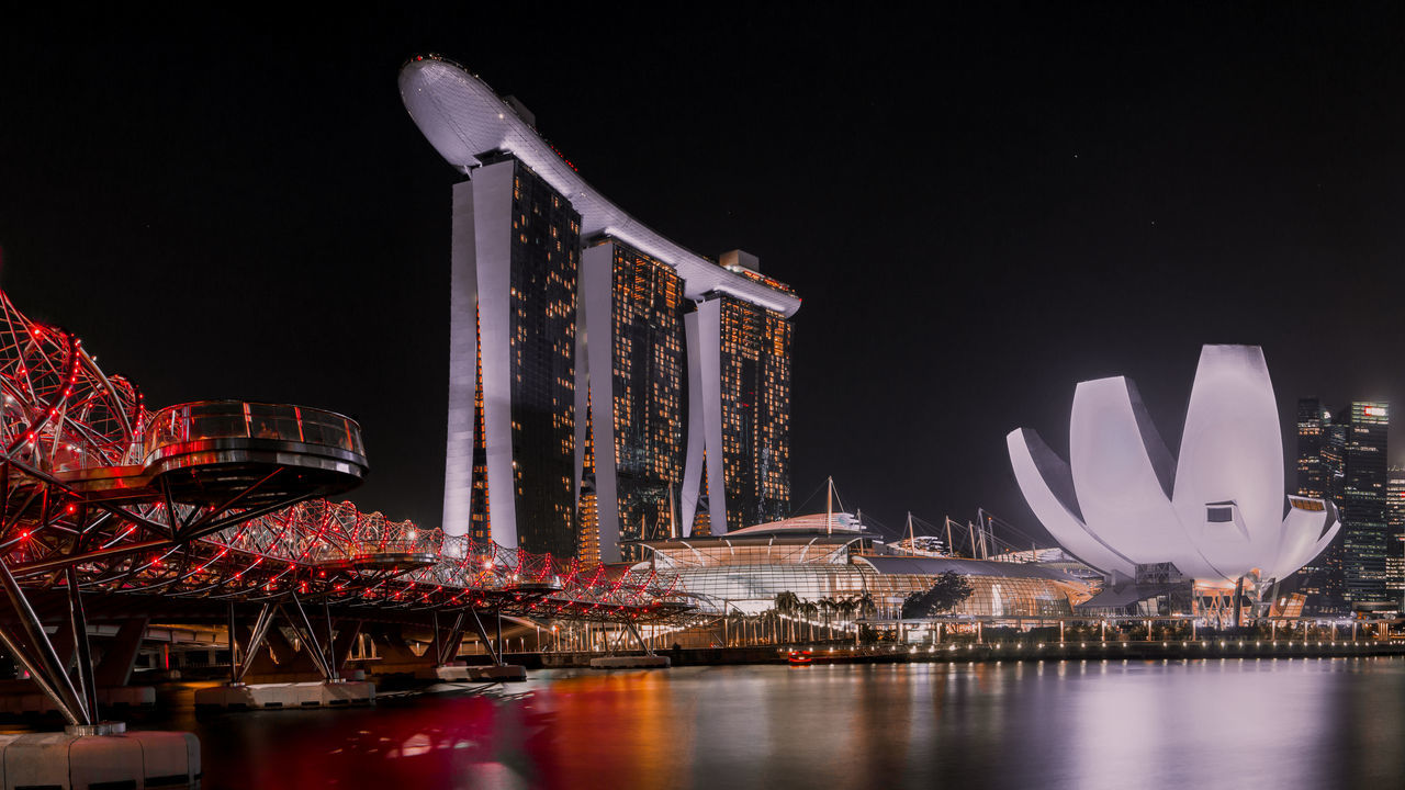 night, architecture, illuminated, built structure, building exterior, water, sky, no people, waterfront, nature, travel destinations, reflection, arts culture and entertainment, luxury hotel, tourism, hotel, travel, outdoors, city, modern, skyscraper, luxury, office building exterior, bay