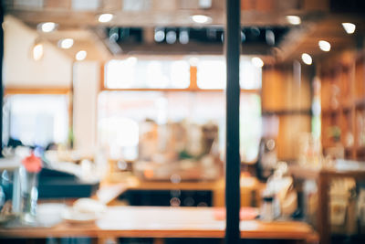 Empty restaurant seen through glass window