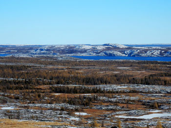 Scenic view of snowcapped mountains against clear blue sky