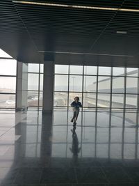 Full length of man walking in airport building