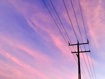 Low angle view of electricity pylon against sky