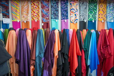 Colorful clothes hanging in store for sale in market