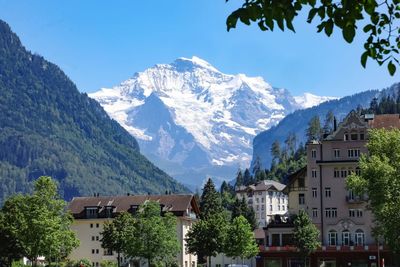 Buildings and mountains against sky