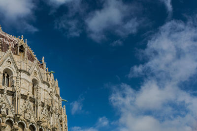 Low angle view of building against cloudy sky