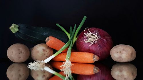 Close-up of fruits on table against black background