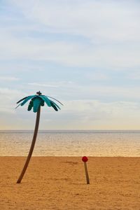 Umbrella on beach against sky