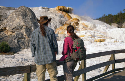 Rear view of couple looking at volcanic landscape