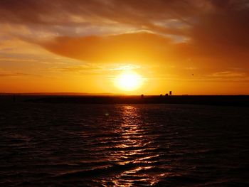 Scenic view of sea against romantic sky at sunset