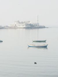 Boat moored in sea against clear sky