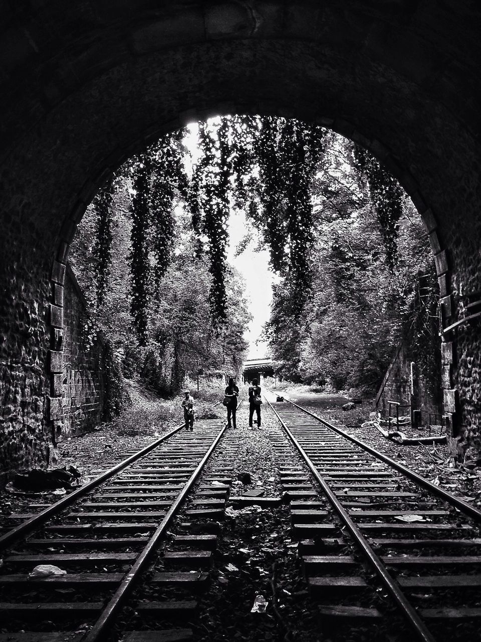 lifestyles, tunnel, walking, the way forward, men, arch, full length, tree, rear view, leisure activity, person, transportation, indoors, diminishing perspective, vanishing point, built structure, architecture