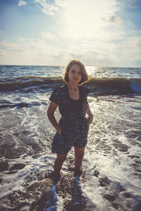 Portrait of woman on beach against sky