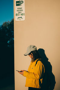 Side view of a person standing against the sky