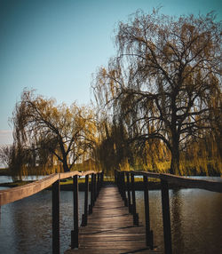 View of pier over lake against clear sky