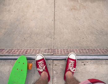 Low section of man standing on road