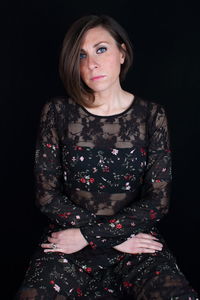 Portrait of woman sitting in darkroom