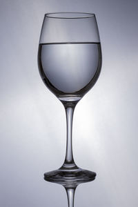 Close-up of wineglass against white background