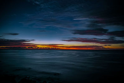 Scenic view of lake against sky at sunset