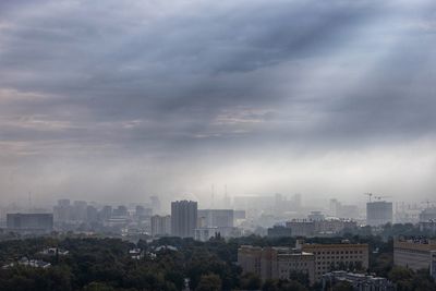 Cityscape against cloudy sky