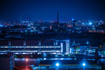 High angle view of illuminated cityscape against sky at night