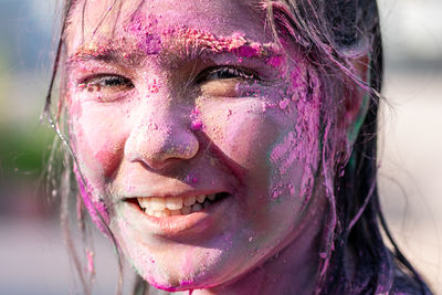Close up portrait of a girl with color on face