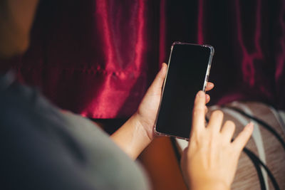 Midsection of man using mobile phone