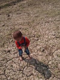 High angle view of boy on rock