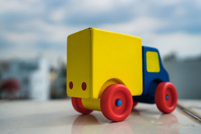 Close-up of yellow toy against blue sky