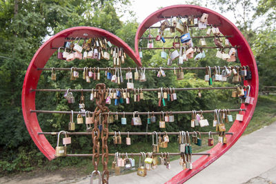 Padlocks on heart shape against trees