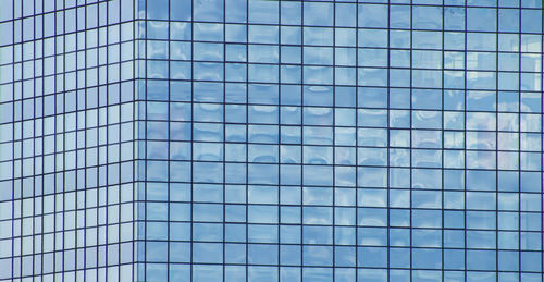 Corner of an office building made of mirrored glass windows. 