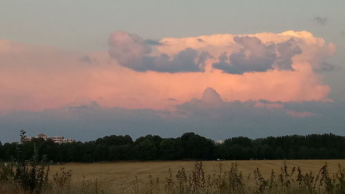 Scenic view of land against sky during sunset