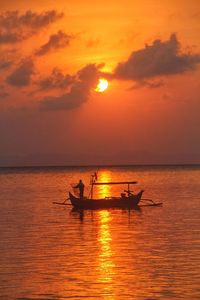 A fisherman working in the morning sunrise