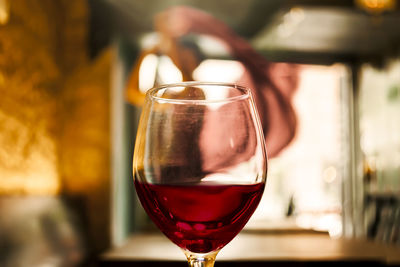 Close-up of wineglass on table at bar