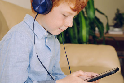 Close-up of boy using mobile phone