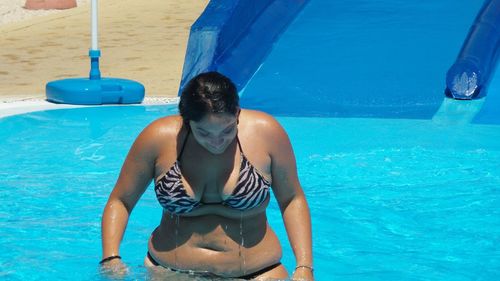 Full length of shirtless man in swimming pool