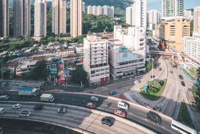 High angle view of cars on highway against buildings in city