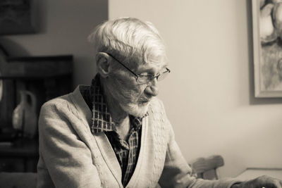 Midsection of man sitting at home