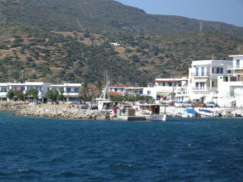 Boats in river with town in background