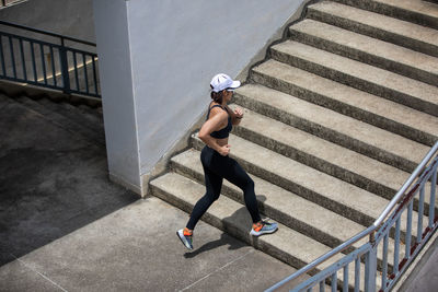 High angle view of woman on staircase in city