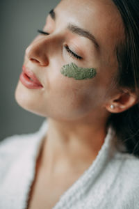 Brunette woman 30 years old with cream on her face