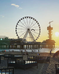 View of ferris wheel against cloudy sky