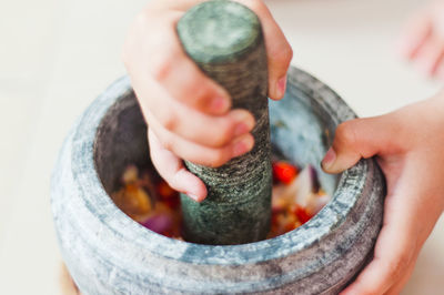 Close-up of person using mortar and pestle