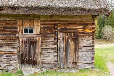 Old weathered timber barn with a thatched roof