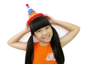 Portrait of a smiling girl against white background