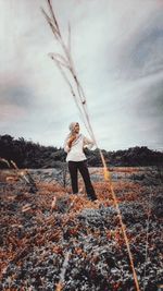 Full length of woman standing against sky during winter