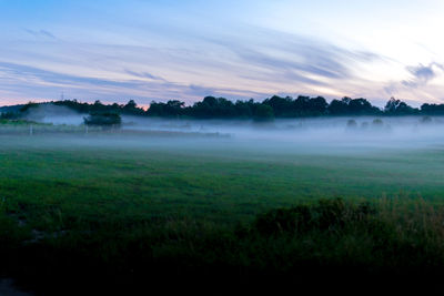 Scenic view of field against sky during sunset